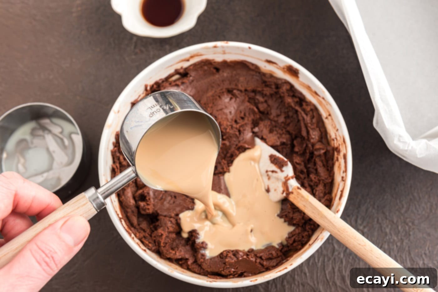 Effortless 4 Ingredient Baileys Fudge 6 Pouring Bailey's Irish cream into the melted chocolate and condensed milk mixture