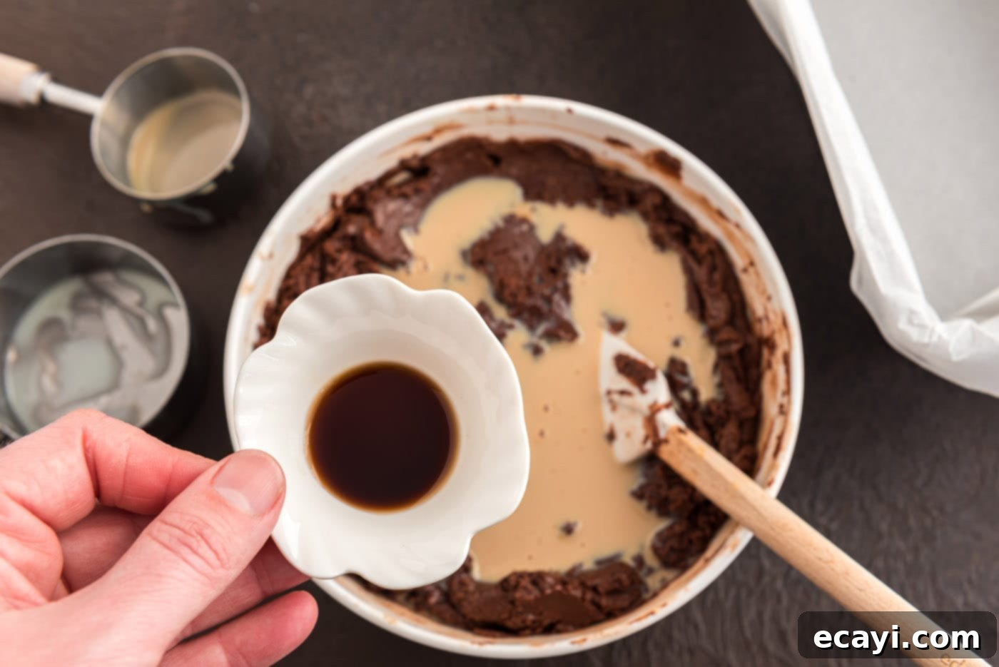 Effortless 4 Ingredient Baileys Fudge 7 Adding vanilla extract to the Bailey's chocolate fudge mixture