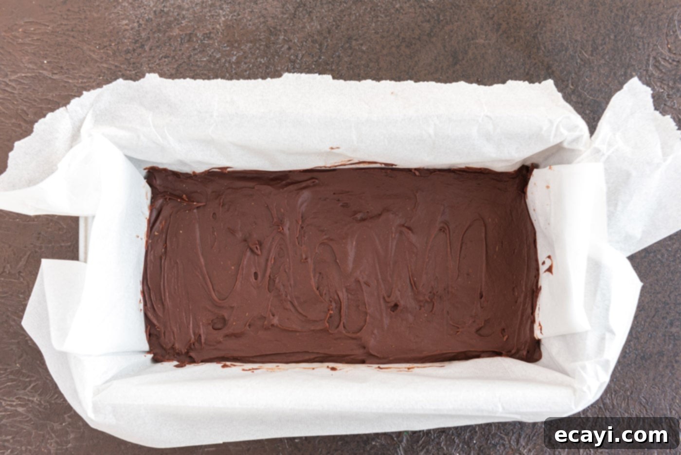 Effortless 4 Ingredient Baileys Fudge 9 Loaf pan filled with no-cook chocolate fudge, chilling in the refrigerator