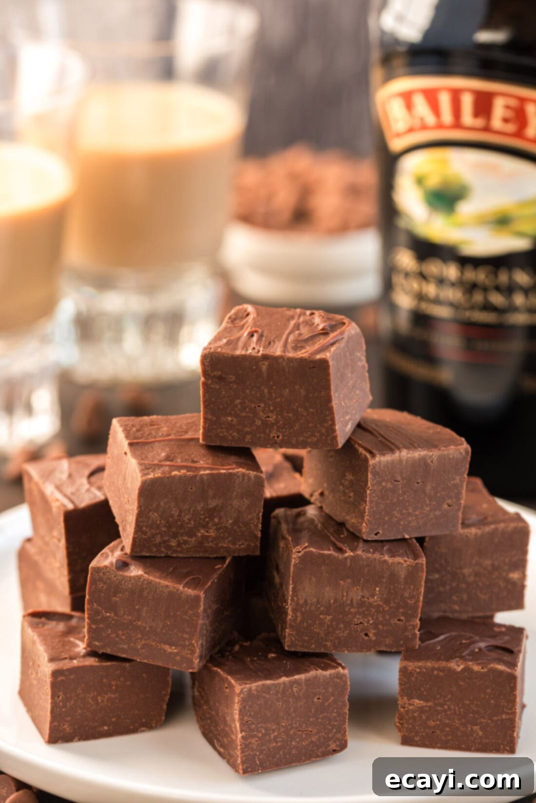 Effortless 4 Ingredient Baileys Fudge 10 Stacked squares of Bailey's fudge, showcasing the rich color and smooth texture