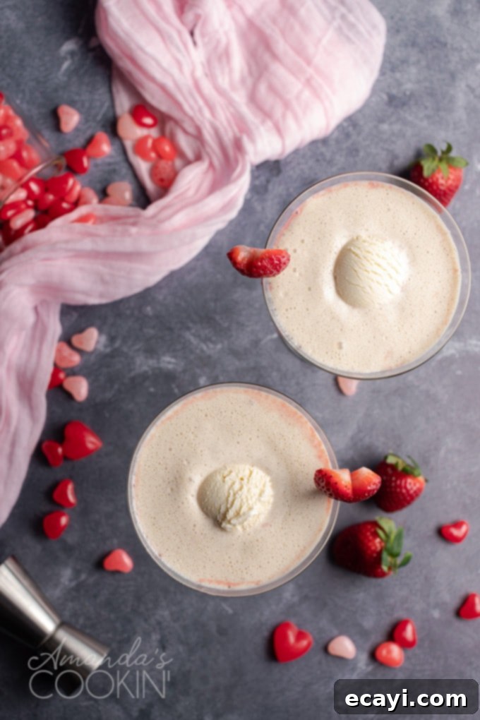This Pink Mudslide uses fresh strawberries and vanilla ice cream along with Irish cream, coffee liqueur, and vodka for an amazing dessert Valentine's drink! Overhead view of a beautifully garnished Pink Mudslide cocktail, ready for Valentine's Day