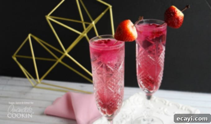 Cupid's Cocktail: The ultimate Valentine's Day champagne and strawberry vodka drink recipe. Cupid's cocktail with strawberry garnish
