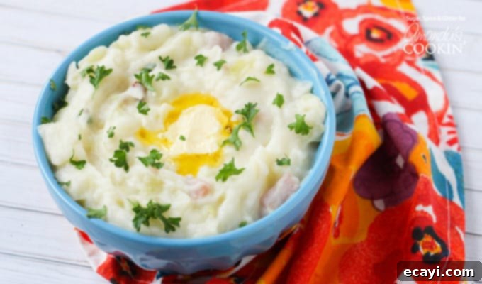 Irish Colcannon 4 A vibrant blue bowl generously filled with Colcannon mashed potatoes, crowned with a sprinkle of fresh parsley and a dollop of melting butter, ready for a comforting meal.