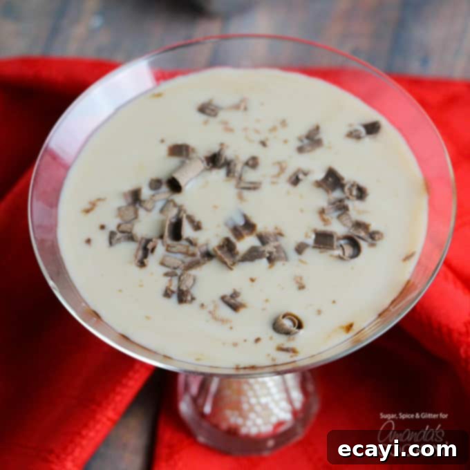 Baileys Chocolate Martini with elegant chocolate shavings. Close-up of a Baileys Chocolate Martini showing decadent chocolate shavings on top, enhancing its visual appeal and rich flavor.