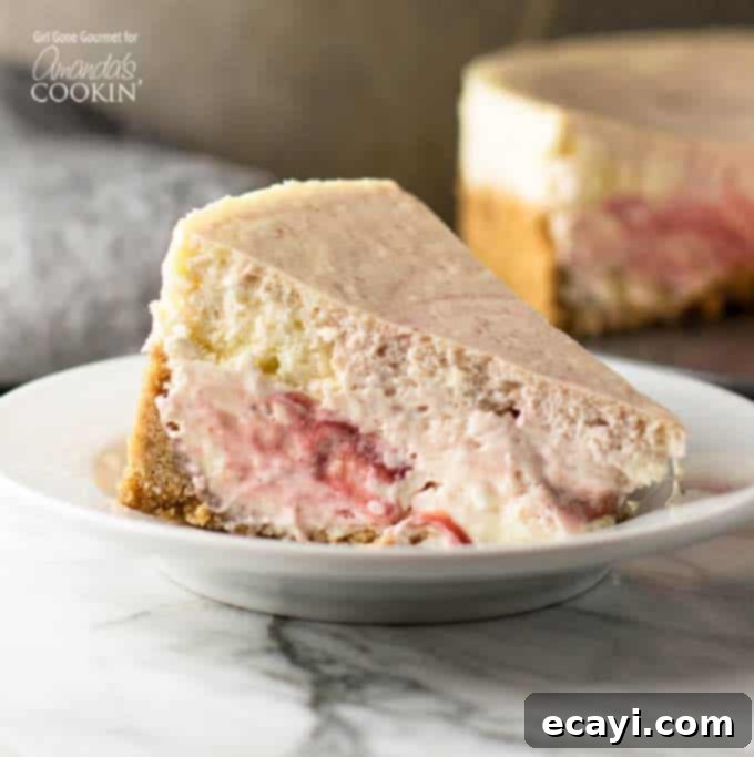 Luscious Strawberry Swirl Cheesecake 3 A perfectly sliced piece of strawberry swirl cheesecake on a white plate, revealing the intricate patterns of the strawberry puree.