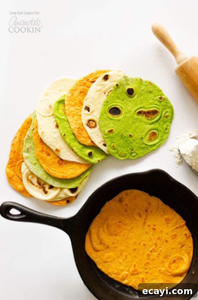 Craft Your Own Flavorful Flour Tortillas 2 An overhead picture of a homemade tortilla resting in a skillet and multiple kinds of homemade tortillas resting on a white cutting board.