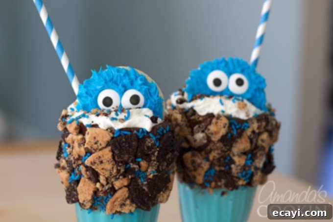 Super cute and easy Cookie Monster Freak Shakes! Two completed Cookie Monster Freak Shakes displayed side by side, highlighting their identical adorable appearance and rich blue color, promising a fun and delicious dessert experience. The focus is on the finished products, ready for enjoyment.