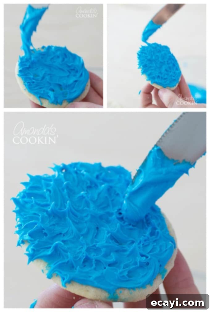 Cookie Monster Freakshakes are fun blue milkshakes topped with Cookie Monster cookies and surrounded by chocolate chip cookie pieces! #cookiemonster #cookiemonstershake #cookiemonsterparty #cookiemonsterrecipes #cookiemonsterfood #freakshake #cookies #icecream #milkshake #shakerecipes #sesamestreet #blueshakes  A baking sheet with freshly baked sugar cookies, some already frosted blue with googly eyes to resemble Cookie Monster, while others await their transformation. A bowl of blue frosting and edible eyeballs are visible, highlighting the step-by-step process of decorating these themed cookies.
