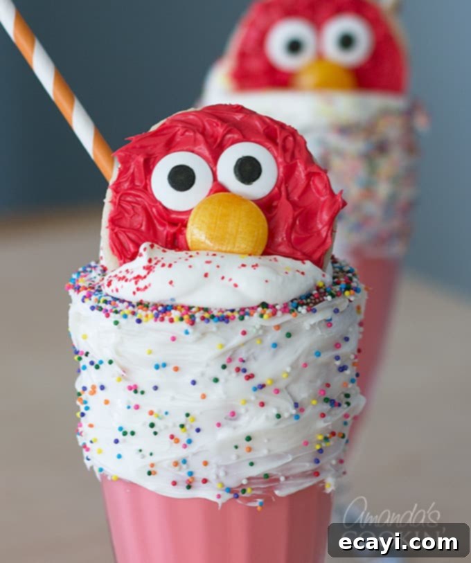 Elmo's Ultimate Freakshakes 2 A brightly colored Elmo Freakshake, perfect for a themed birthday party or fun treat, showcasing its festive sprinkles and cookie topper.