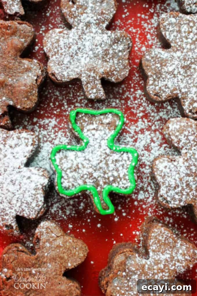 Lucky Clover Brownie Bites 3 Close-up of a stack of shamrock shaped brownies, highlighting their fudgy texture.