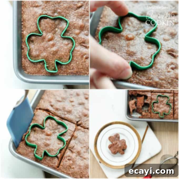 Lucky Clover Brownie Bites 6 Hands demonstrating cutting out a brownie with a shamrock cookie cutter on a cutting board.