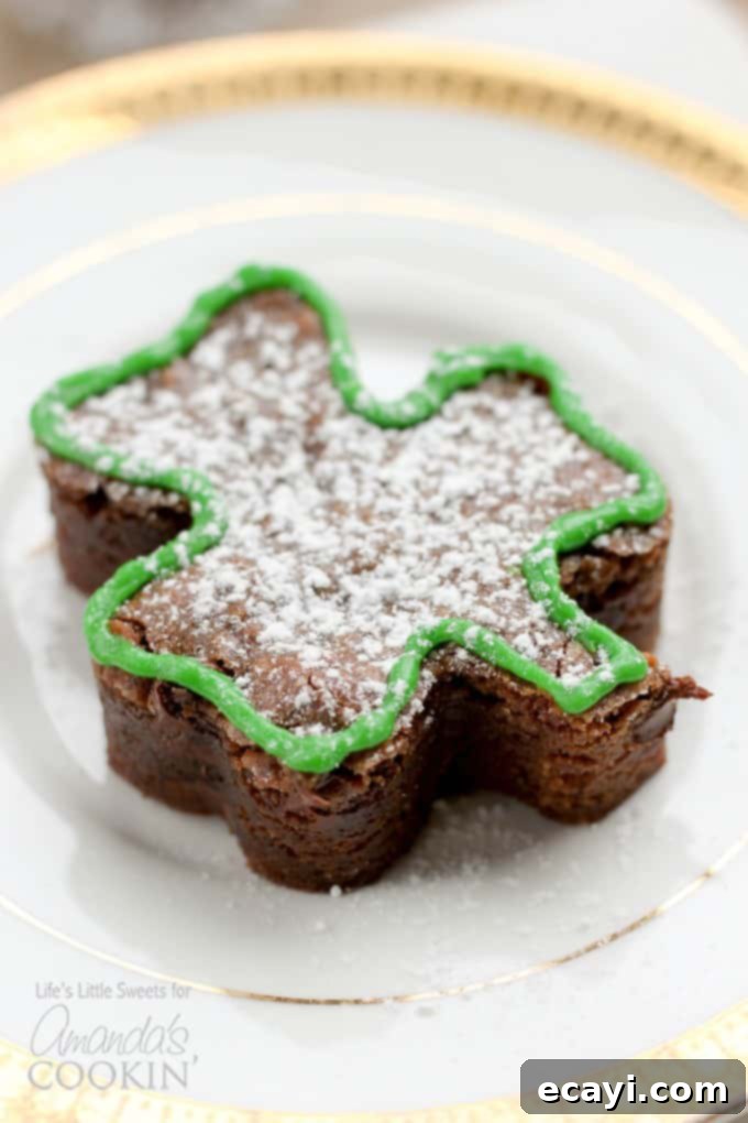 Lucky Clover Brownie Bites 8 Multiple shamrock shaped brownies arranged on a rustic wooden board, ready to be enjoyed.