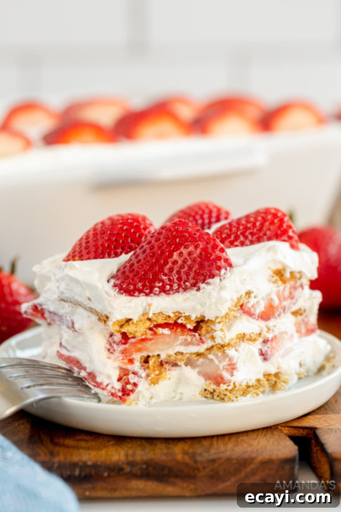Strawberry Cloud Cake 2 slice of strawberry icebox cake, showing layers of whipped cream, strawberries, and graham crackers