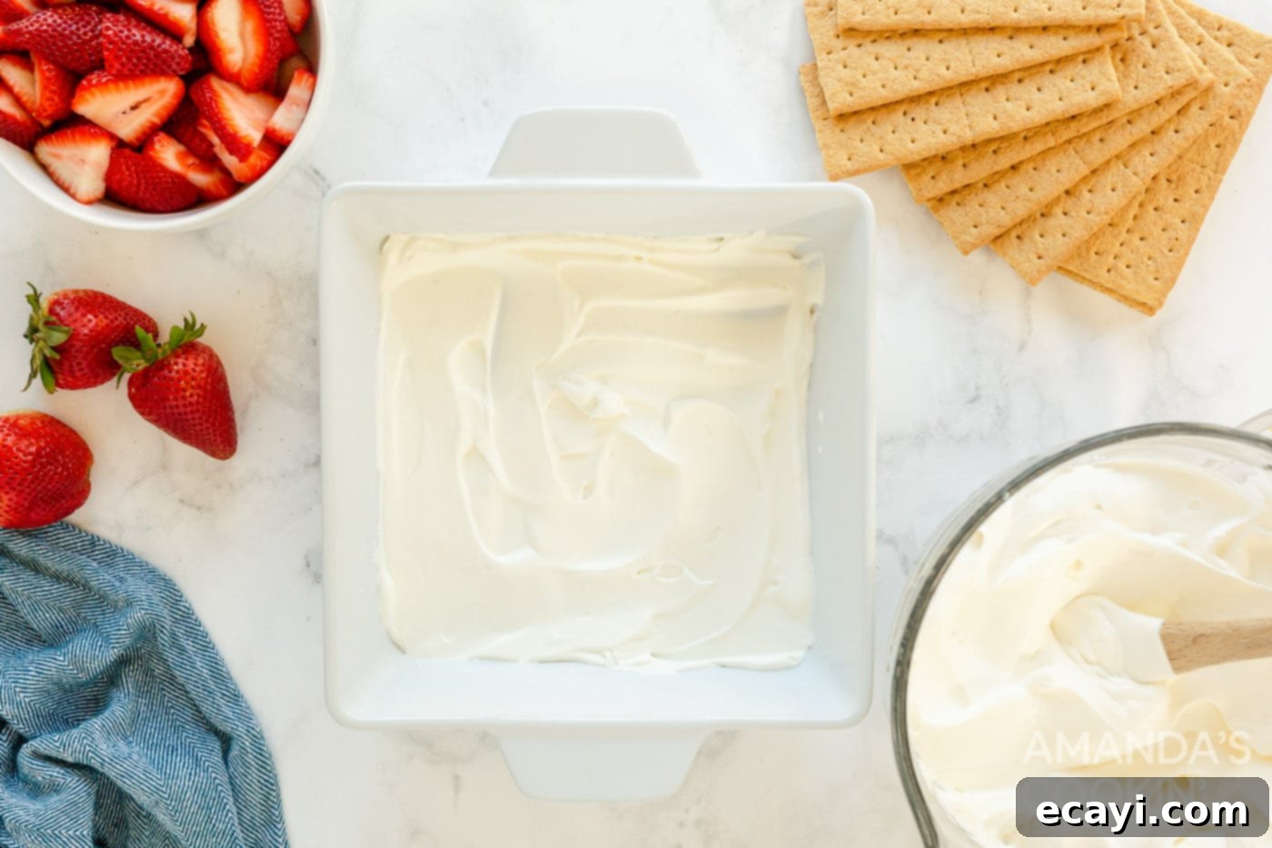 Strawberry Cloud Cake 5 thin layer of whipped cream spread at the bottom of a baking dish