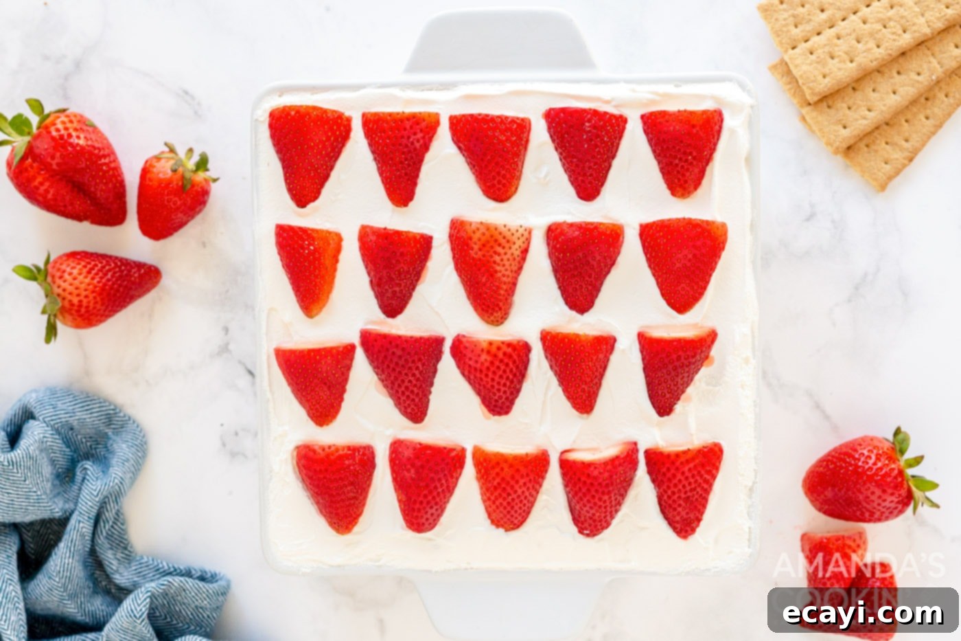 Strawberry Cloud Cake 10 overhead photo of sliced strawberries arranged beautifully on top of whipped cream
