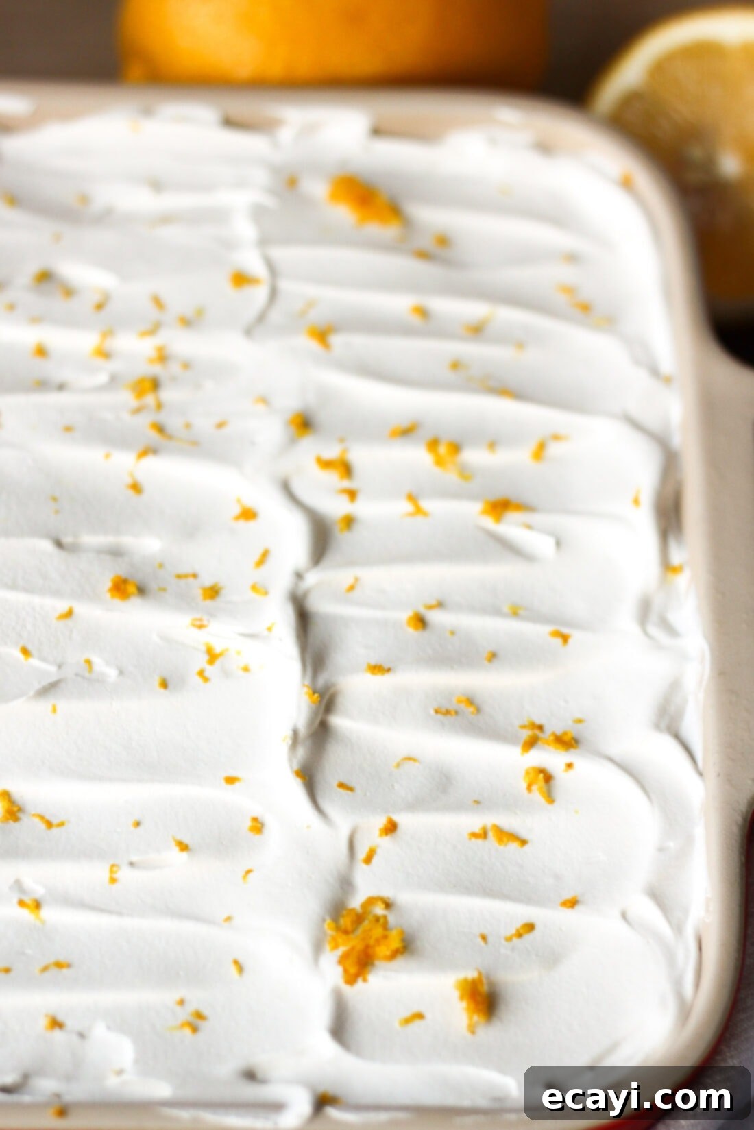 Lemon Lush. It's light and refreshing with 4 layers consisting of bottom pecan crust, lemon cream cheese, lemon pudding and topped with a whipped layer garnished with lemon zest. #lemonlush #lemondessert #lemonlasagna #nobake #onepandesserts #potluckdesserts #creamcheesedesserts #puddingdesserts  Pan of Lemon Lush