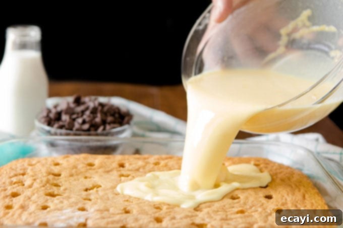 Boston Cream Infusion Dream 4 pouring thin pudding over cake with holes in it