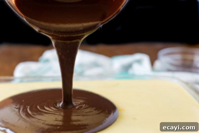 Boston Cream Infusion Dream 5 pouring chocolate over pudding layer on cake