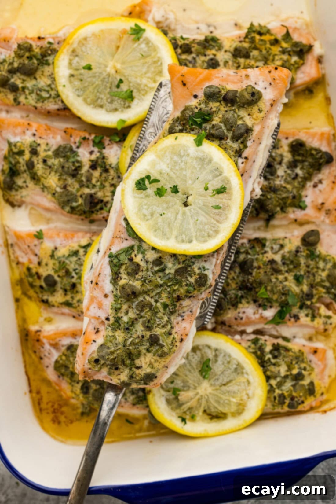 Zesty Lemon Caper Salmon 3 Spatula lifting up a Lemon Caper Salmon filet