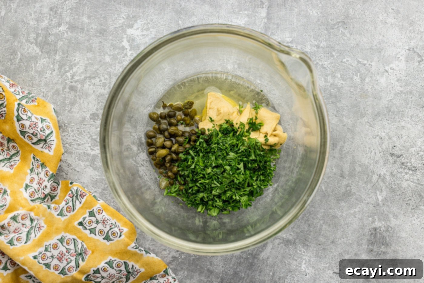 Zesty Lemon Caper Salmon 5 lemon juice, capers, parsley, dijon mustard, and olive oil in a bowl