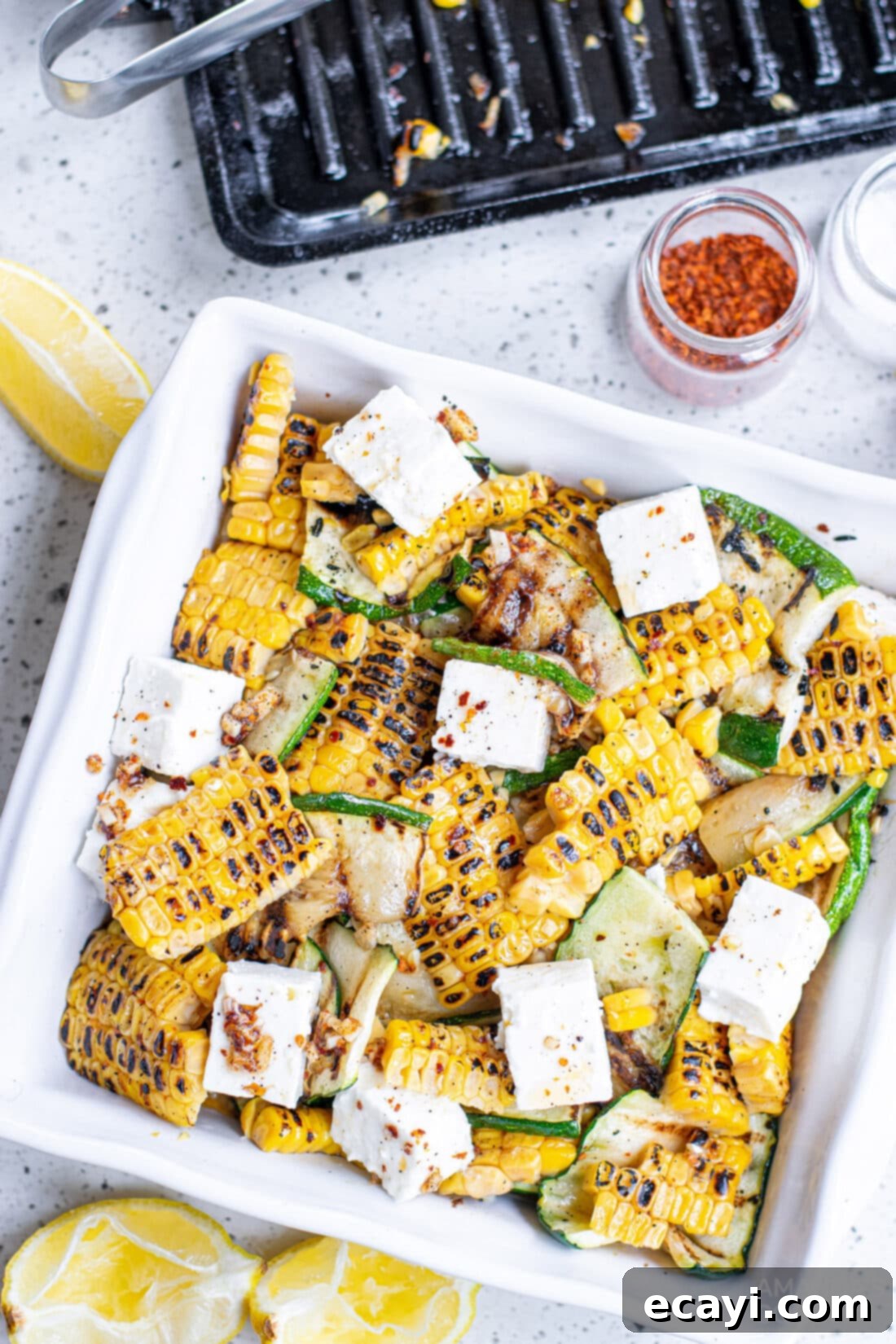 Grilled Corn, Zucchini and Feta Salad 2 A vibrant bowl of Grilled Corn & Zucchini Salad with Feta, showcasing char-grilled vegetables and crumbled cheese.