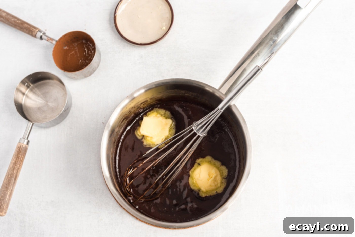 Decadent Eclair Delight 12 whisking softened butter into the chocolate mixture in a saucepan