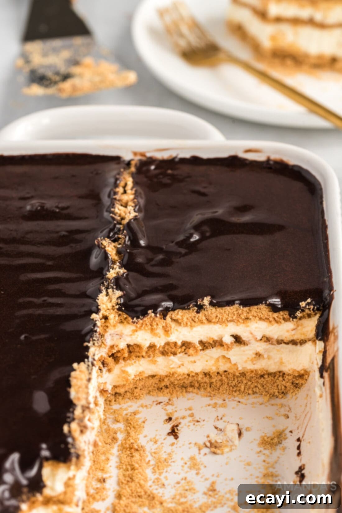 Decadent Eclair Delight 3 A full pan of no bake eclair cake, ready to be sliced, showcasing the smooth chocolate topping
