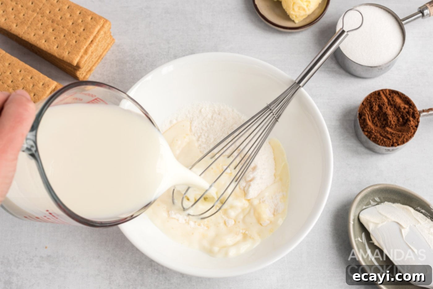 Decadent Eclair Delight 5 milk pouring into pudding powder in a mixing bowl