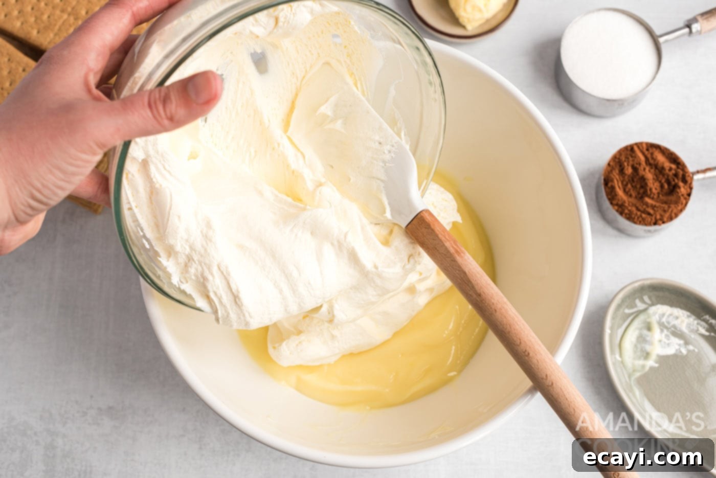 Decadent Eclair Delight 6 adding whipped topping to pudding mix in a bowl