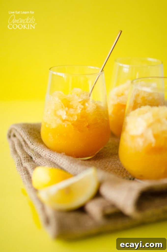 This Easy Bourbon Slush has just 5 ingredients and comes together in minutes! Just mix it, freeze it, and forget it until you’re ready to enjoy! #slush #slushie #adultslushie #slushierecipes #bourbonrecipes #bourboncocktails #summercocktails #drinkswithbourbon #cocktailswithbourbon #summerdrinks Bourbon Slush in glasses