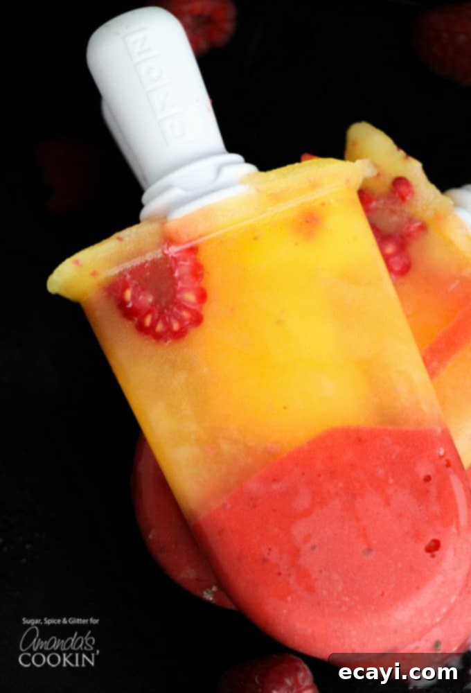 Refreshing Raspberry Mango Popsicles 2 Delicious boozy frozen mango raspberry popsicles, brightly colored and inviting.