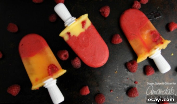 Refreshing Raspberry Mango Popsicles 5 Closeup of refreshing mango raspberry popsicles, showcasing their vibrant colors and smooth texture.