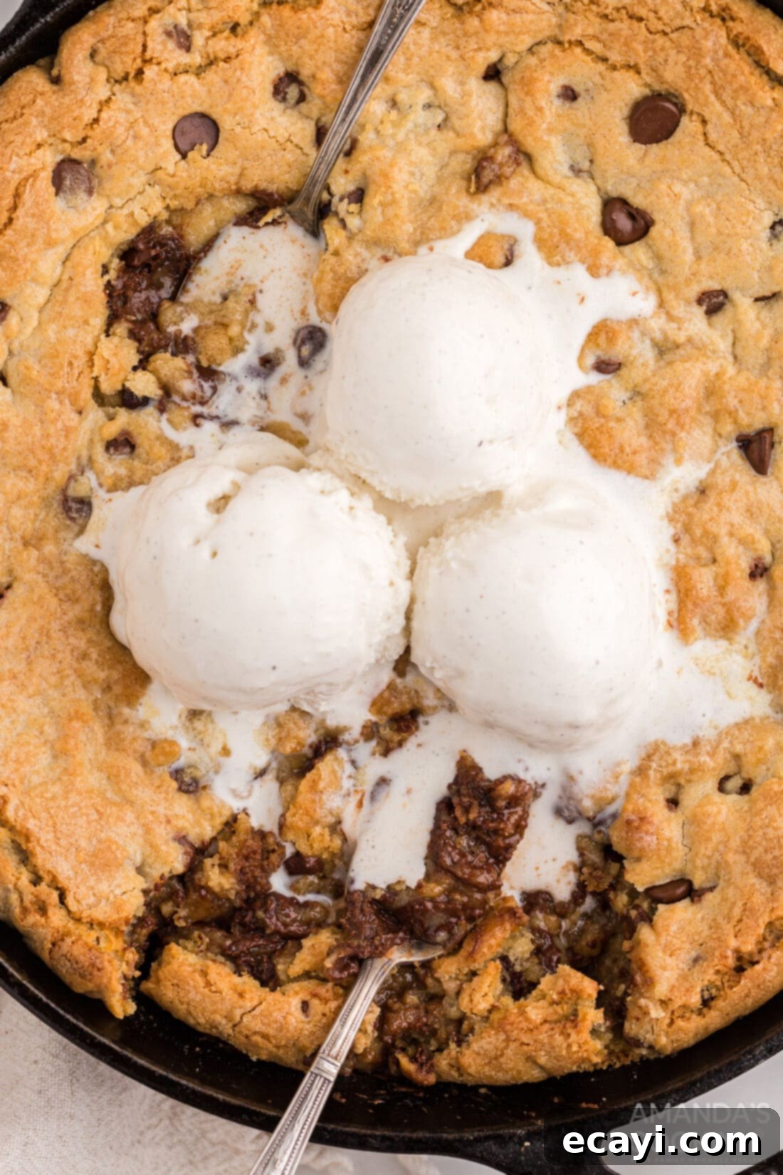 Decadent Skillet Chocolate Chip Cookie 2 Warm skillet chocolate chip cookie topped with melting vanilla ice cream and chocolate syrup drizzle