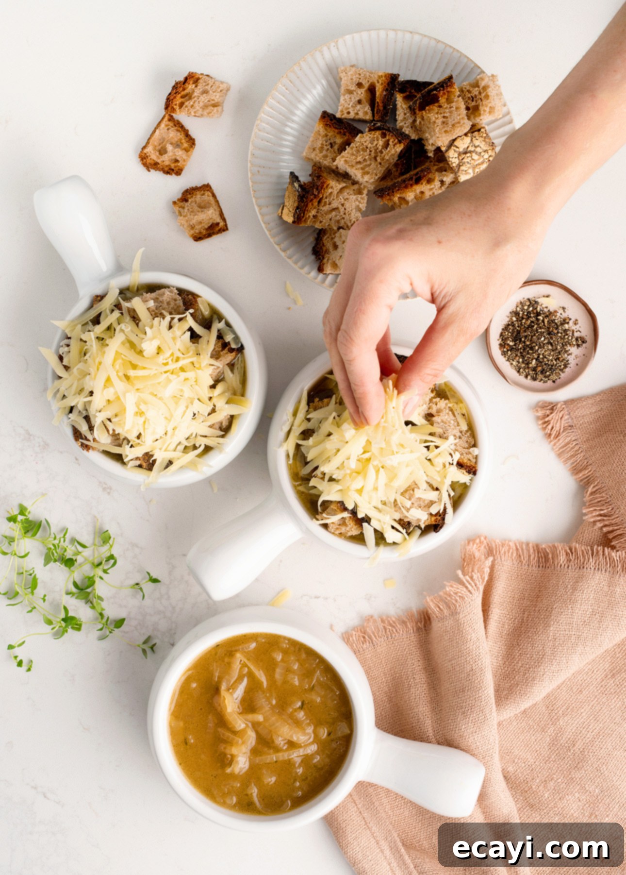Perfect Homemade French Onion Soup 8 Adding croutons and grated cheese to classic French onion soup // FoodNouveau.com