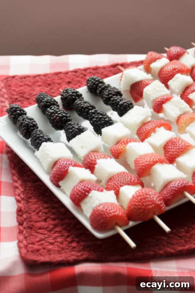 Serve these super easy and healthy American Flag Kabobs for Memorial Day or Fourth of July. A delicious fruit dessert alternative! American Flag kabobs made from fresh fruit and angel food cake, arranged on a platter