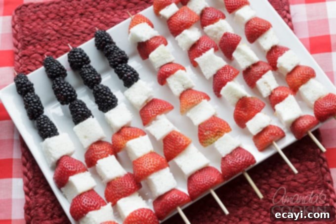 These American Flag Kabobs are incredibly easy to assemble for your Memorial Day or Fourth of July party, offering a healthy and delicious dessert alternative! Close-up of Fourth of July American Flag Fruit Kabobs with fresh berries
