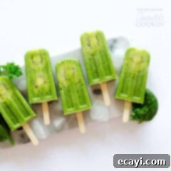 Vibrant Green Smoothie Pops 2 green popsicles on a plate of ice