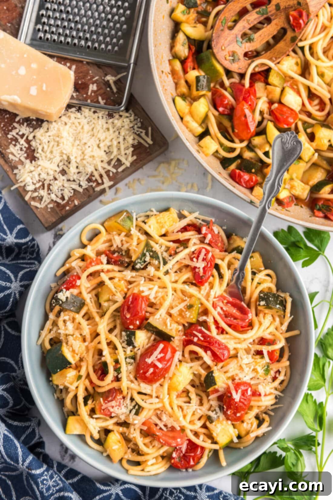 Summer Zucchini Tomato Pasta 2 Bowl of Simple Zucchini Tomato Pasta topped with fresh parmesan and herbs, showcasing vibrant summer vegetables and a light sauce.