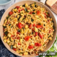 Summer Zucchini Tomato Pasta 12 Skillet of Simple Zucchini Tomato Pasta, perfectly cooked and ready to serve, with a focus on its fresh ingredients.