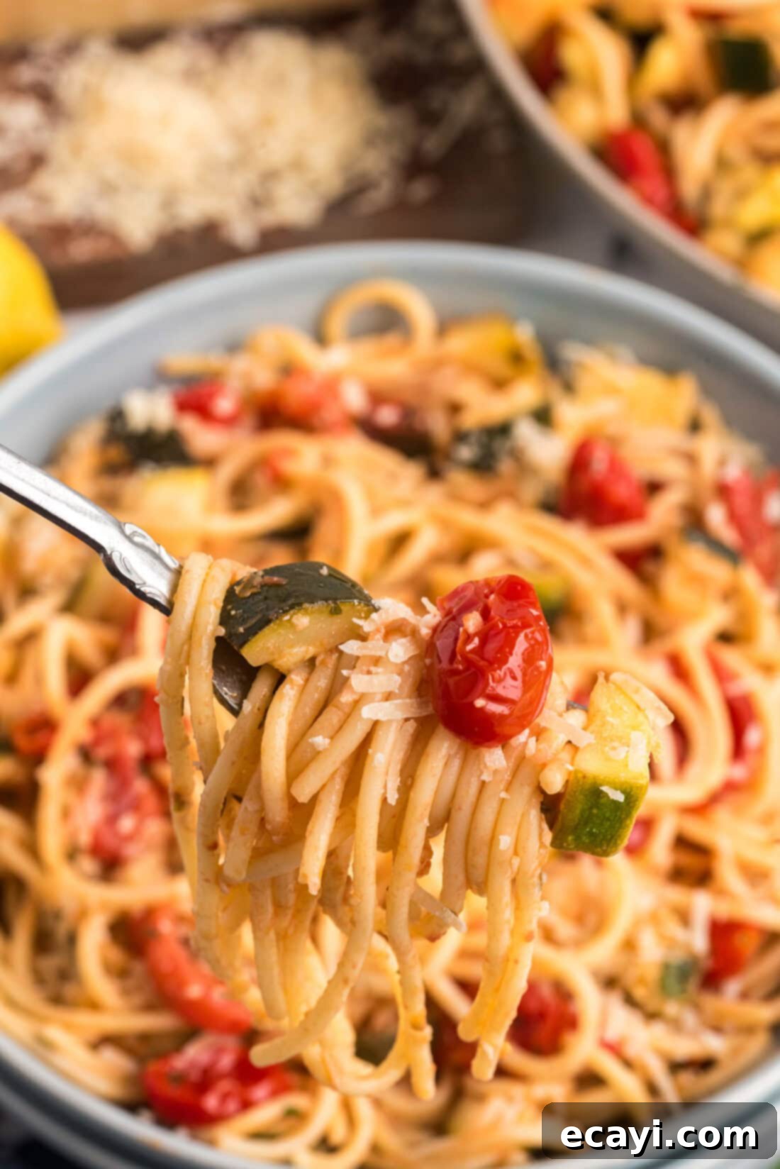 Summer Zucchini Tomato Pasta 3 Simple Zucchini Tomato Pasta twisted on a fork, showing the vibrant colors of the dish and its tender texture.