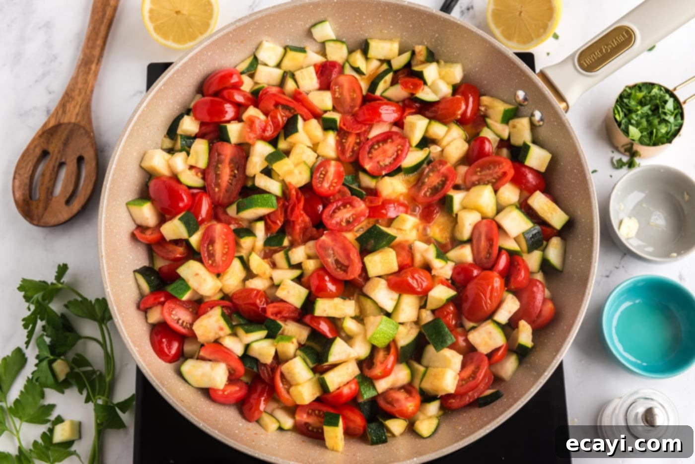 Summer Zucchini Tomato Pasta 6 Cooked zucchini and burst tomatoes simmering in a skillet, creating a rich, natural sauce from their juices.