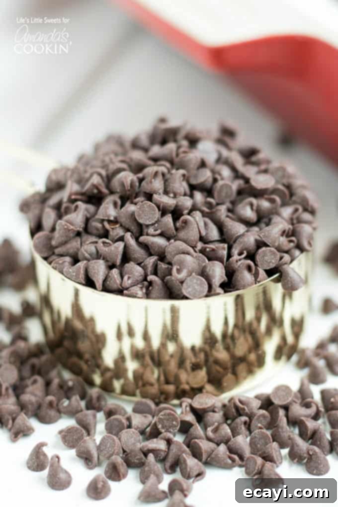 This Mocha Lush recipe is a light, airy and cool dessert that serves up delicious, chocolatey, mocha flavor. One-pan Mocha Lush is perfect for potlucks! chocolate chips in a measuring cup, ready for topping Mocha Lush