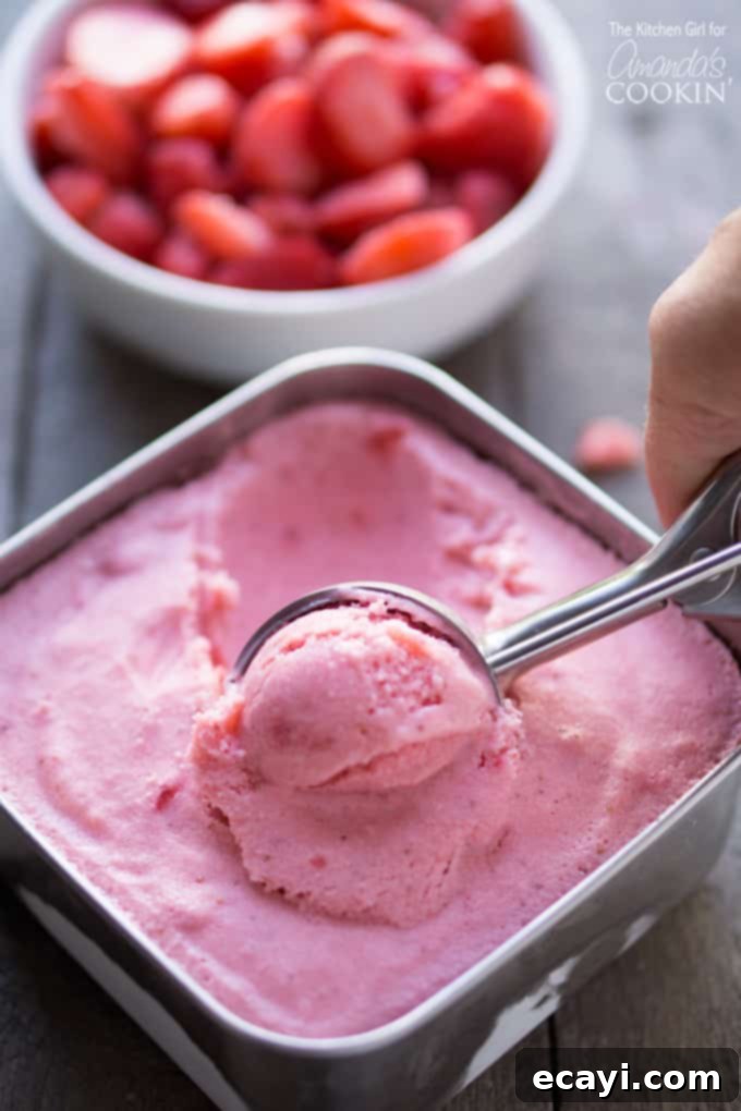 Strawberry Frozen Yogurt might just become your new favorite summer recipe! It’s so easy, light, and delicious, you’ll wonder why you never made it before! Scooping homemade strawberry frozen yogurt from a bowl