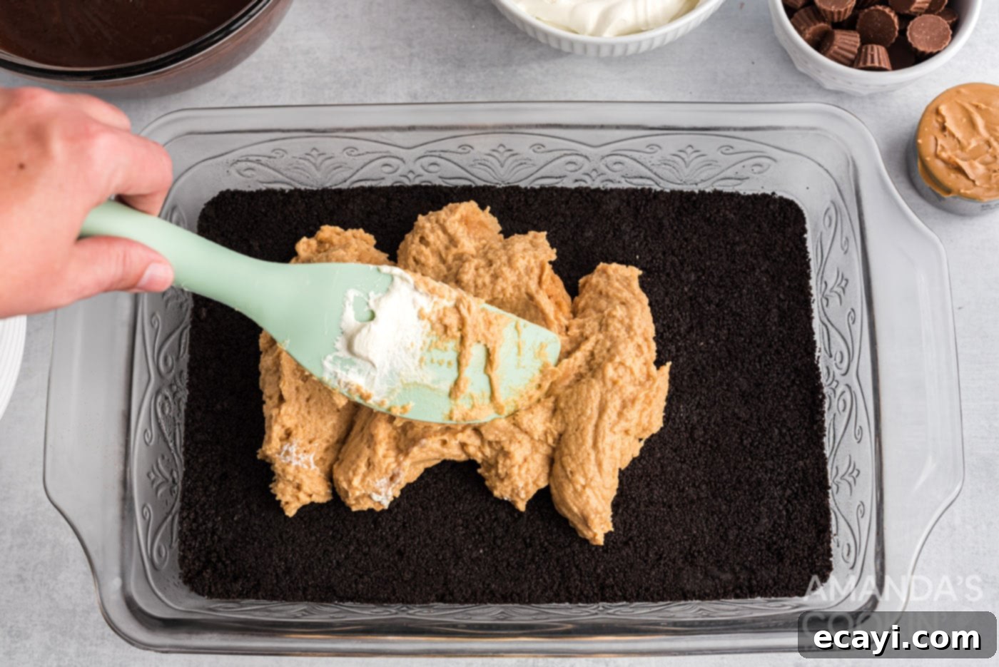 Decadent Chocolate Peanut Butter Stack 11 rubber spatula spreading out cream cheese peanut butter mixture
