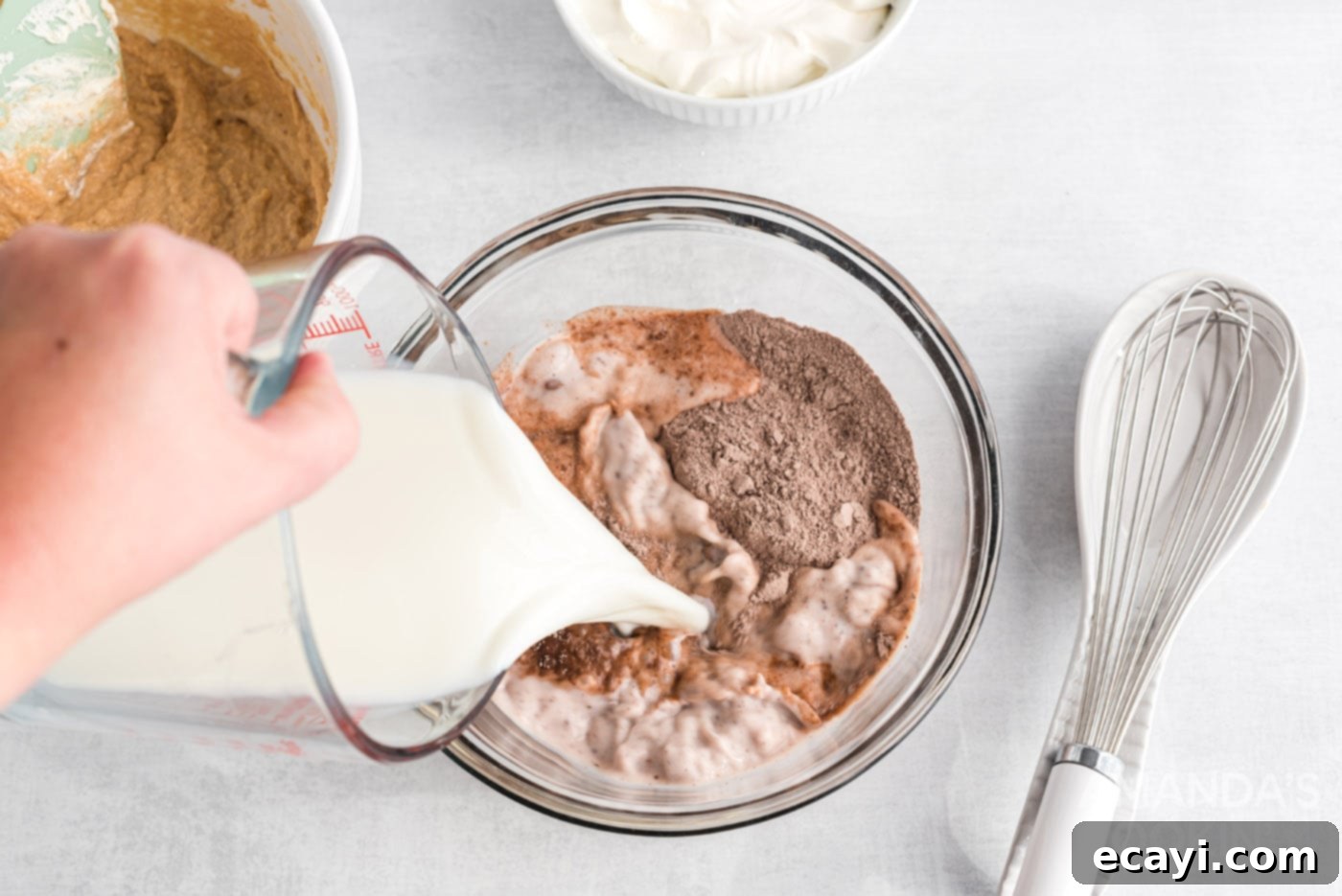Decadent Chocolate Peanut Butter Stack 9 pouring milk into instant pudding