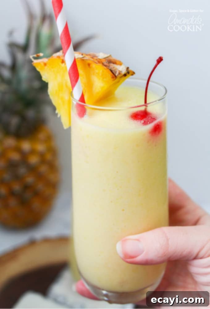Expanding the normal selection of frozen cocktails from daiquiris and frozen margaritas to include wine-based cocktails or fresh fruit varieties like this Pineapple Rum Slush #mixeddrinks #rumdrinks #slushies #cocktails Glass of Pineapple Rum Slush