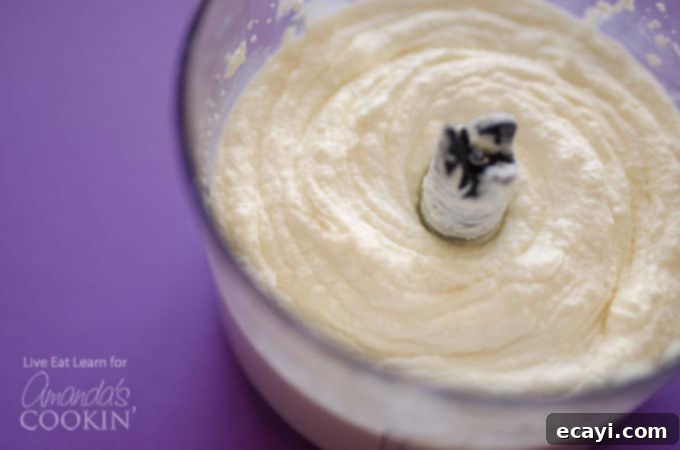 Simple Steps to Make Fluffy Ricotta Whipped Feta in Your Food Processor Ricotta and feta cheese being whipped in a food processor to create a smooth dip