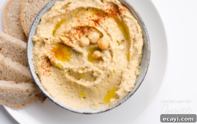 From roasted eggplant to creamy blend, discover how easy it is to make this flavorful Baba Ganoush Hummus at home. #eggplant #hummus #vegetarian #chickpeas #healthyrecipes #dips #appetizers Step-by-step process of making Baba Ganoush Hummus, showing roasted eggplant and ingredients in a food processor