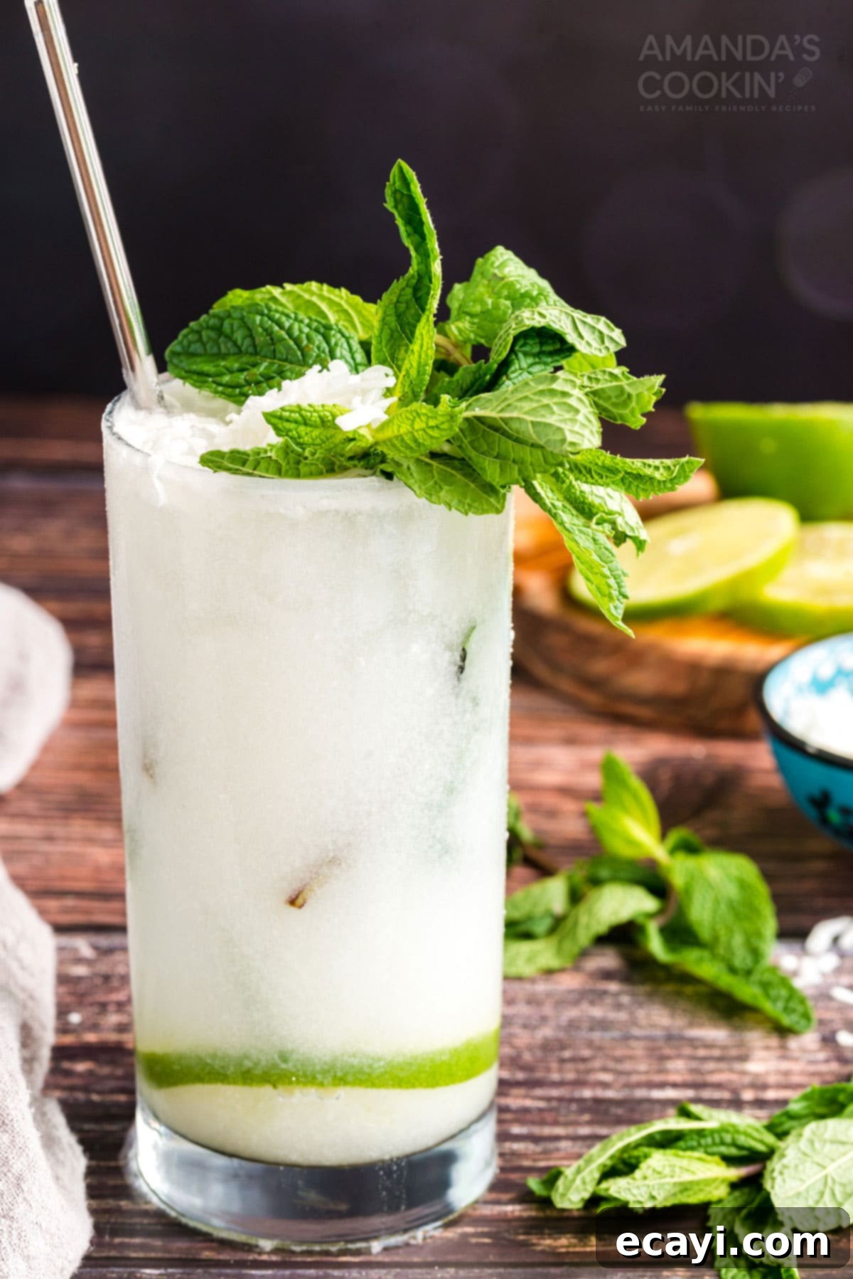 This refreshing Coconut Mojito is made with fresh cooling mint, coconut rum, coconut cream and club soda. A delicious and tropical cocktail for summer! glass of coconut mojito garnished with mint