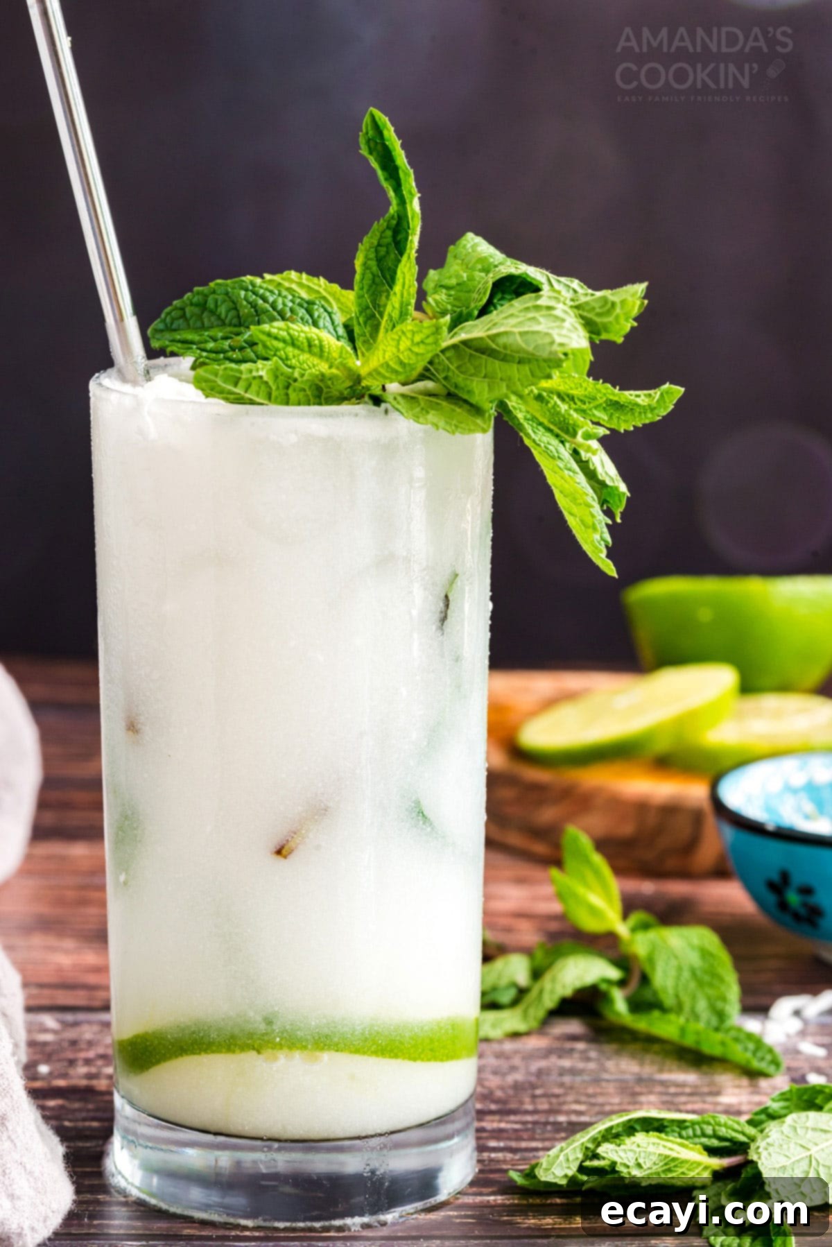 This refreshing Coconut Mojito is made with fresh cooling mint, coconut rum, coconut cream and club soda. A delicious and tropical cocktail for summer! mojito in a glass made with coconut rum and coconut cream